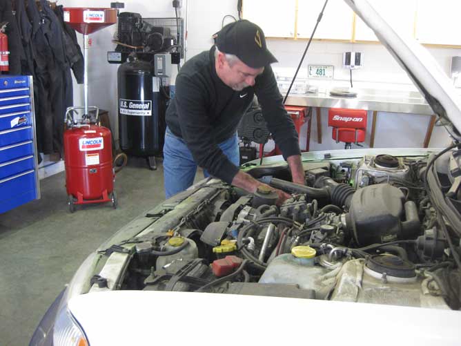 Subaru mechanic, Brent Lindquist working on a Subaru engine